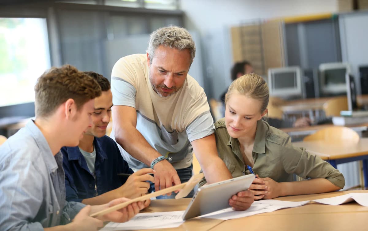 Diverse students and teacher in a modern classroom with technology integration